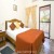 AC bedroom with attached shower bath and toilet.
